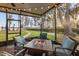 Inviting screened patio features a modern fire pit and comfortable seating with a scenic view at 21918 Shamu Dr, Land O Lakes, FL 34639