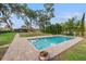 Outdoor swimming pool with a brick paver surround at 21918 Shamu Dr, Land O Lakes, FL 34639