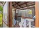 Outdoor shower with sink, mirror, and propane-powered water heater at 21918 Shamu Dr, Land O Lakes, FL 34639
