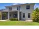 Charming backyard with screened lanai, upper balcony and manicured lawn at 2463 Carnation Ct, North Port, FL 34289
