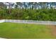 A scenic view of the backyard featuring a white picket fence and lush greenery, creating a private outdoor space at 2463 Carnation Ct, North Port, FL 34289