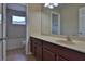 Bathroom featuring a cherry-wood vanity and a combined shower and bathtub combo at 2463 Carnation Ct, North Port, FL 34289