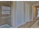 Bathroom featuring a glass shower, tile flooring, and closet space nearby at 2463 Carnation Ct, North Port, FL 34289