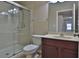 Bathroom featuring a glass shower, vanity sink, and toilet in a neutral setting at 2463 Carnation Ct, North Port, FL 34289