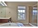 Bright bathroom features a shower, garden tub, large window, and cherry-wood vanity at 2463 Carnation Ct, North Port, FL 34289