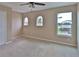 Empty bedroom features arched windows for viewing nature and one square window at 2463 Carnation Ct, North Port, FL 34289