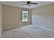 Carpeted bedroom with neutral walls, a ceiling fan, and a large window with blinds at 2463 Carnation Ct, North Port, FL 34289