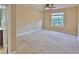 Light-filled bedroom featuring neutral walls, carpet, and a window with tree view at 2463 Carnation Ct, North Port, FL 34289