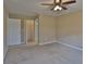 Empty bedroom with a ceiling fan and walk in closet shown through doorway at 2463 Carnation Ct, North Port, FL 34289