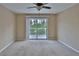 Spacious bedroom with sliding glass doors to a balcony overlooking greenery at 2463 Carnation Ct, North Port, FL 34289