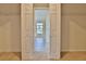 Walk-in closet with double doors leading into a well lit room with tiled floors at 2463 Carnation Ct, North Port, FL 34289