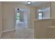 Carpeted hallway leading to additional rooms, with neutral wall paint at 2463 Carnation Ct, North Port, FL 34289