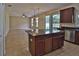 Open kitchen featuring an island and view to adjacent living area at 2463 Carnation Ct, North Port, FL 34289