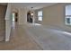 Spacious living area with carpet and tile flooring and staircase at 2463 Carnation Ct, North Port, FL 34289