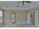Spacious main bedroom features ceiling fan, tray ceiling and neutral wall color at 2463 Carnation Ct, North Port, FL 34289