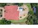 An aerial view features a single-Gathering home with a large terracotta roof, a pool, and a waterfront lot at 2613 N Dundee St, Tampa, FL 33629