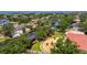 A stunning aerial view showcases a waterfront property with lush landscaping and boat dock at 2613 N Dundee St, Tampa, FL 33629