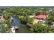 An aerial view of a beautiful waterfront house with a pool and boat dock with lift at 2613 N Dundee St, Tampa, FL 33629