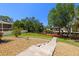 A lush backyard features a boat dock, wooden deck and stone path leading to a home, perfect for outdoor relaxation and entertainment at 2613 N Dundee St, Tampa, FL 33629
