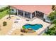 A beautiful outdoor living space is shown, including a freeform pool, stone patio, and lounge furniture at 2613 N Dundee St, Tampa, FL 33629
