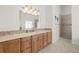 Light filled bathroom boasts a spacious vanity with double mirrors and luxurious stone countertop at 2613 N Dundee St, Tampa, FL 33629