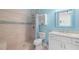 Stylish bathroom with tiled shower, bright blue accents, and modern vanity at 2613 N Dundee St, Tampa, FL 33629