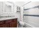 Bright bathroom features a shower with white tile and decorative mosaic accents and a vanity at 2613 N Dundee St, Tampa, FL 33629