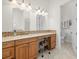 Bathroom features a large vanity area with stone countertop, lighting, and a doorway to a toilet at 2613 N Dundee St, Tampa, FL 33629