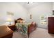 Well-lit bedroom with wood furniture, soft carpet, and large windows offering great natural light at 2613 N Dundee St, Tampa, FL 33629