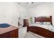 Cozy bedroom with wood furniture, soft carpet, and an ensuite bathroom and closet at 2613 N Dundee St, Tampa, FL 33629