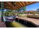 A covered boat dock featuring a boat lift with a house in the background, providing convenience and protection for waterfront property owners at 2613 N Dundee St, Tampa, FL 33629