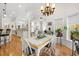 Bright dining area with a view, featuring hardwood floors and a stylish chandelier at 2613 N Dundee St, Tampa, FL 33629
