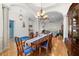 Open dining room with hardwood floors, chandelier, and decorative columns at 2613 N Dundee St, Tampa, FL 33629