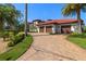 Beautiful brick driveway leads to a three-car garage with lush landscaping around the home at 2613 N Dundee St, Tampa, FL 33629