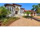 Stately home showcasing a grand staircase leading to double doors and a circular turret-style window feature at 2613 N Dundee St, Tampa, FL 33629
