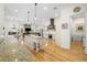 Gourmet kitchen features an island, granite counters, hardwood floors, and stainless steel appliances at 2613 N Dundee St, Tampa, FL 33629