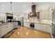 Bright open kitchen with stainless steel appliances, a stone fireplace, and island seating at 2613 N Dundee St, Tampa, FL 33629
