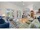 Open-concept living space with hardwood floors, neutral paint, and ample seating with lots of sunlight at 2613 N Dundee St, Tampa, FL 33629