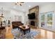 Comfortable living room boasts a stone fireplace and French doors leading to the outside at 2613 N Dundee St, Tampa, FL 33629