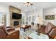 Bright living room featuring a stone fireplace, built-in shelving, and comfortable leather seating at 2613 N Dundee St, Tampa, FL 33629