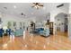 Open-concept living space with hardwood floors, ceiling fans, and views into other living areas at 2613 N Dundee St, Tampa, FL 33629
