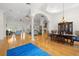 Open-concept living and dining area with hardwood floors, elegant columns, and ample natural light at 2613 N Dundee St, Tampa, FL 33629