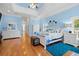 Cozy main bedroom with decorative tray ceiling, hardwood floors, and ample closet space at 2613 N Dundee St, Tampa, FL 33629