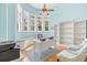 Bright office space with built-in shelving, work space, and sunny bay window sitting area at 2613 N Dundee St, Tampa, FL 33629