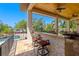 Outdoor bar with counter seating is covered with a ceiling fan, overlooking the pool at 2613 N Dundee St, Tampa, FL 33629