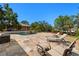 Loungers next to the pool offer a relaxing space in a well-manicured backyard setting at 2613 N Dundee St, Tampa, FL 33629
