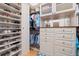 Custom walk-in closet with built-in shelving, drawers, and cabinets providing ample storage space at 2613 N Dundee St, Tampa, FL 33629