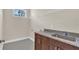 Laundry room with granite countertops, stainless sink, and custom cabinets at 2627 Hancock St, Plant City, FL 33563