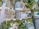 Aerial view of a property with an outlined lot, two storage sheds, a home, and a swimming pool at 2719 Boca Ciega N Dr, St Petersburg, FL 33710