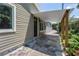 View of the back patio, showing hexagon tiles, siding, and partial roof coverage from home at 2719 Boca Ciega N Dr, St Petersburg, FL 33710